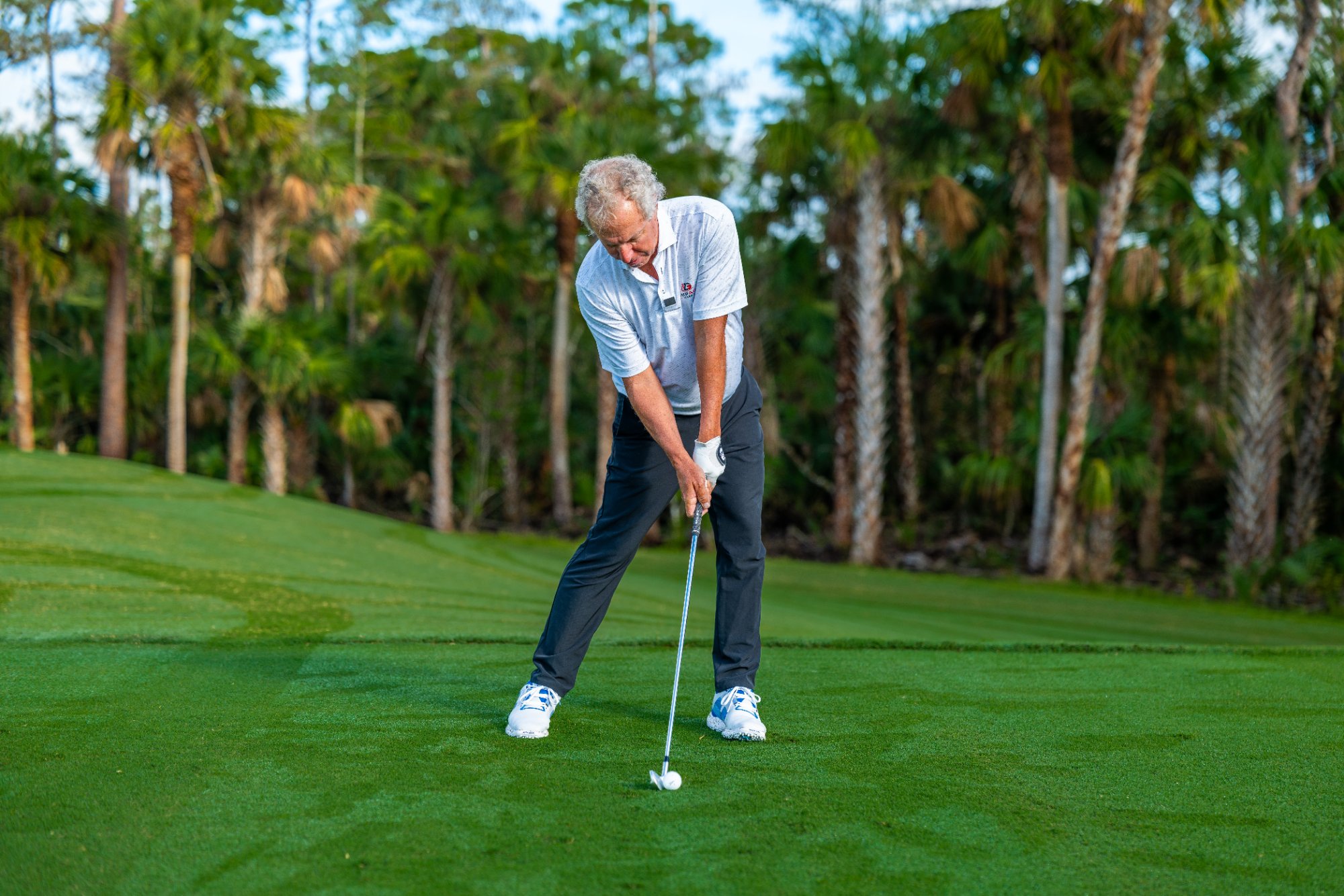 Bobby Clampett demonstrating impact-focused golf instruction
